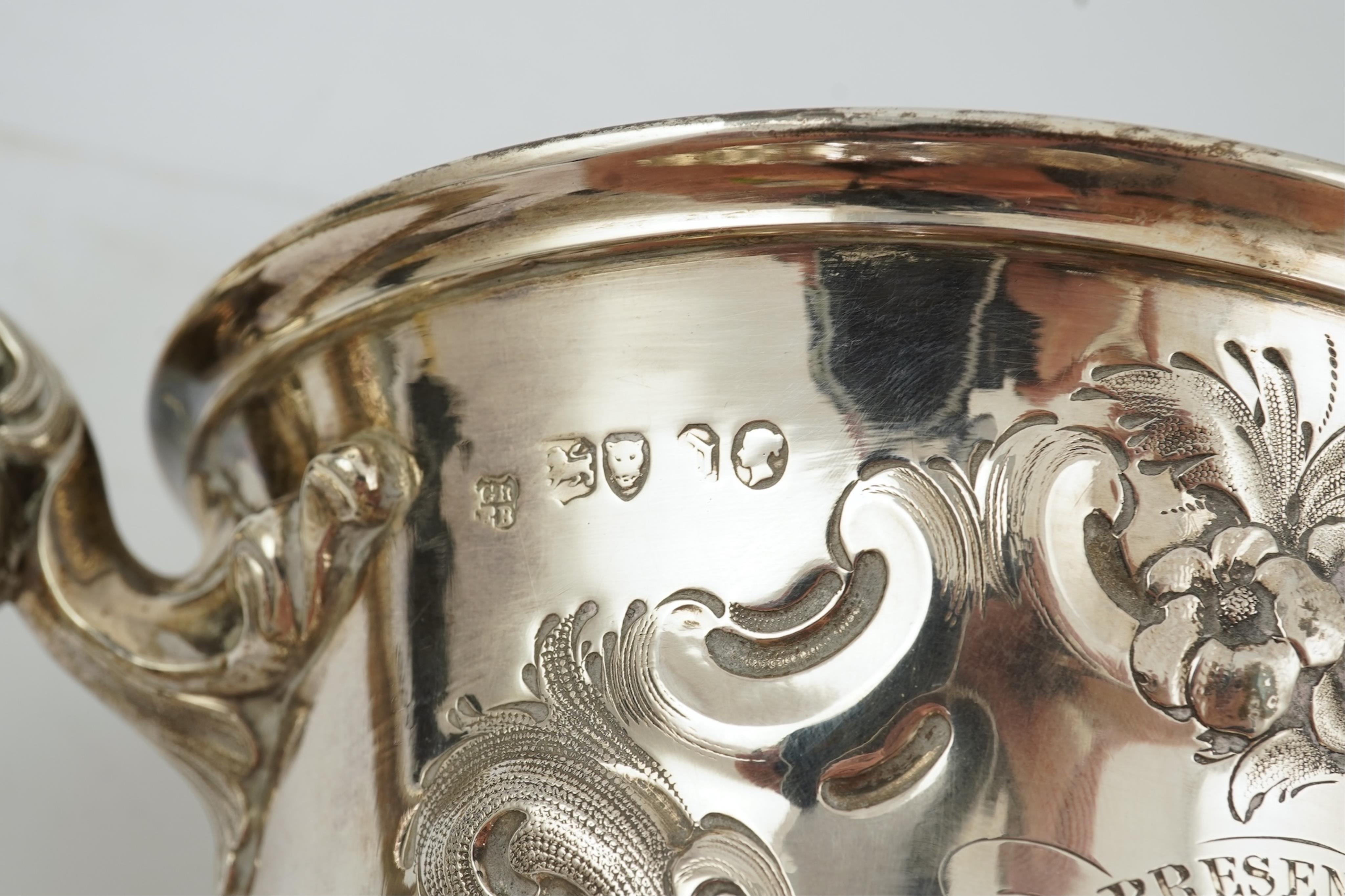 A Victorian embossed silver two handled presentation trophy cup by George John Richards & Edward Charles Brown